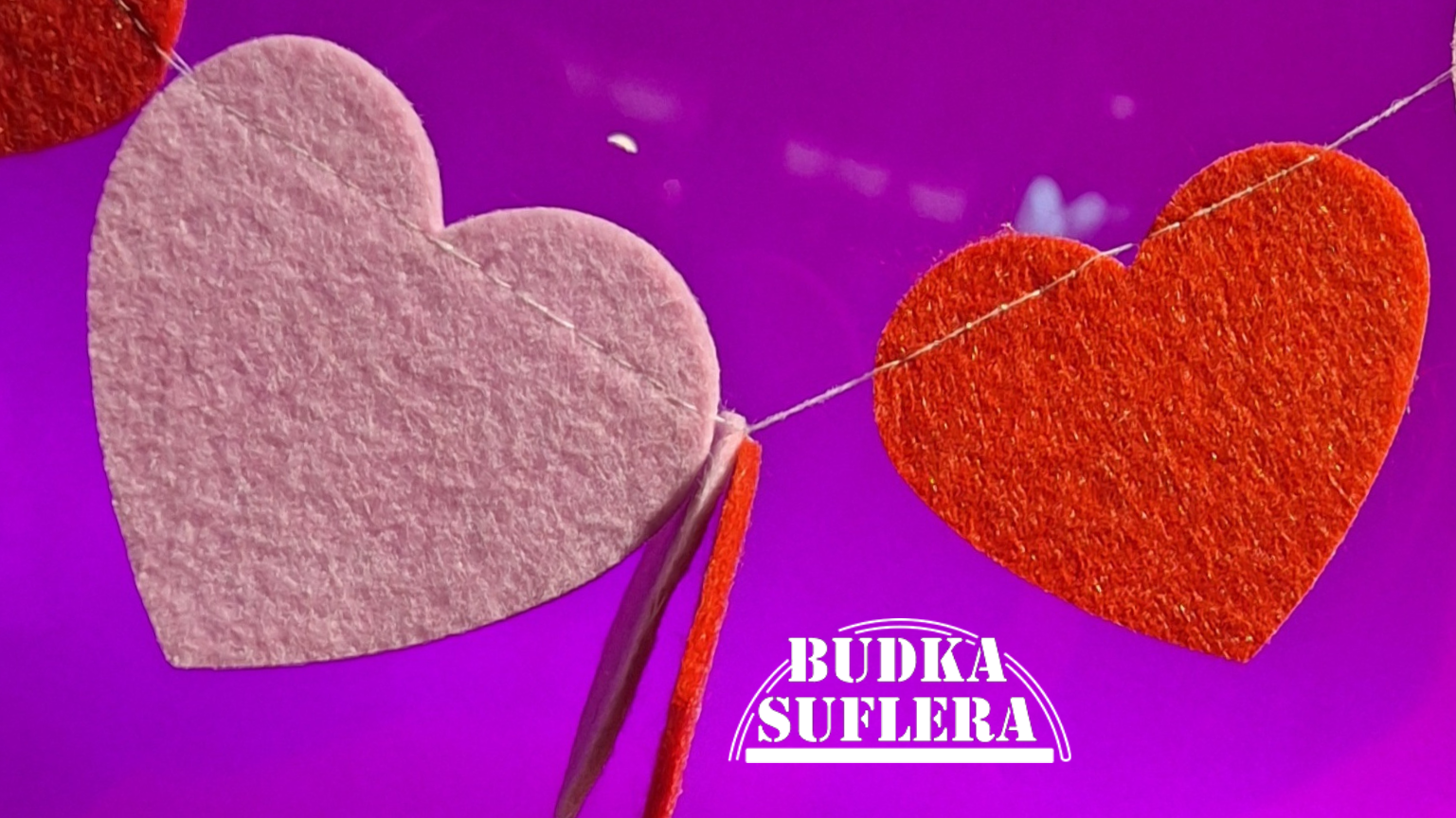 Kolorowa grafika z serduszkami i logo Budki Suflera